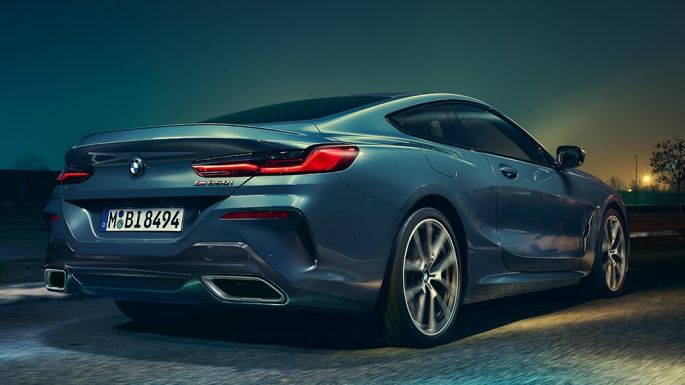 BMW M850i xDrive kupė, vaizdas iš galo BMW M850i xDrive kupė Barcelona Blue mėlyno metaliko spalvos, naktį važiuojančio automobilio vaizdas iš galo