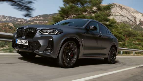 M sportinė pakaba, BMW X4 M40i G02 LCI Facelift 2021 važiuojančio kalvų fone automobilio trijų ketvirčių vaizdas iš priekio BMW X4 M40i M40d G02 LCI 2021 pilkos Frozen Deep Grey spalvos, M sportinė pakaba, važiuojančio kalvų fone automobilio vaizdas iš priekio