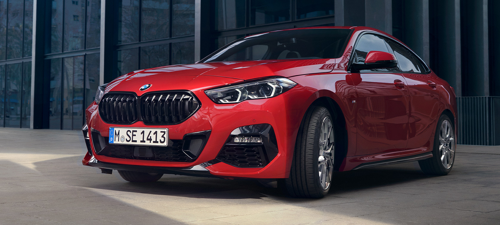 BMW 2 serijos Gran kupė F44 trijų ketvirčių vaizdas iš priekio <i>Edition ColorVision</i> raudonos metalizuotos <i>Melbourne Red</i> kėbulo spalvos BMW 2 serijos Gran kupė F44 trijų ketvirčių vaizdas iš priekio pastato fone <i>Edition ColorVision</i> raudonos metalizuotos <i>Melbourne red</i> kėbulo spalvos