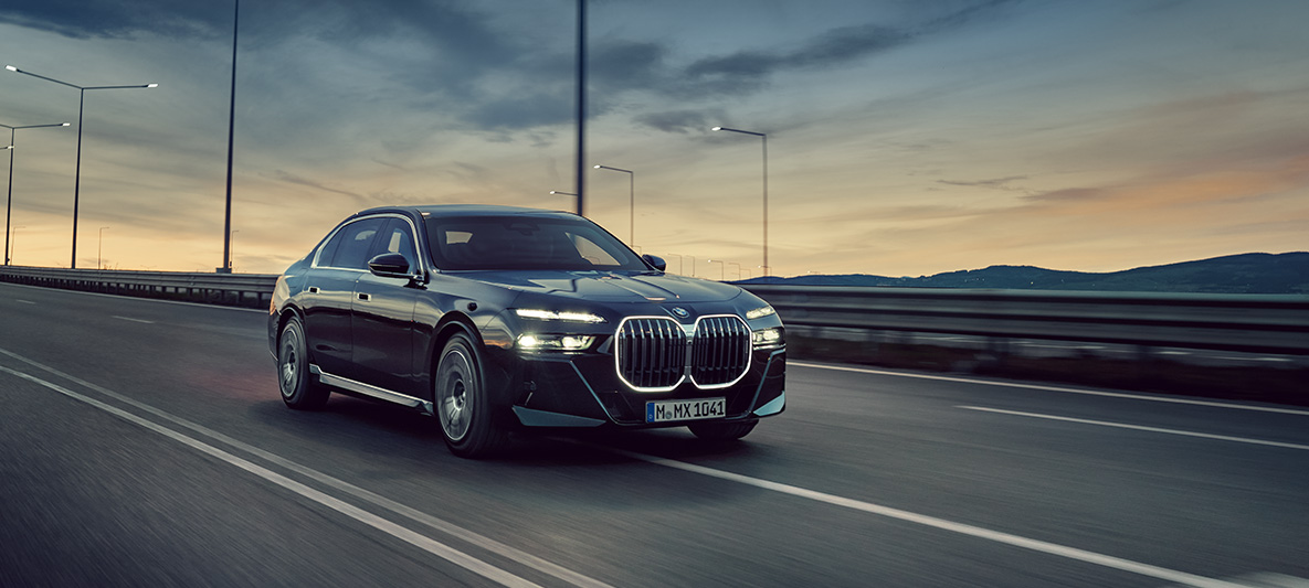 BMW apsauginiai automobiliai, BMW apsaugos vairuotojo mokymų kursas BMW apsauginių automobilių vairavimo mokymai apsaugos vairuotojams, gatvėje važiuojančio BMW trijų ketvirčių vaizdas iš priekio